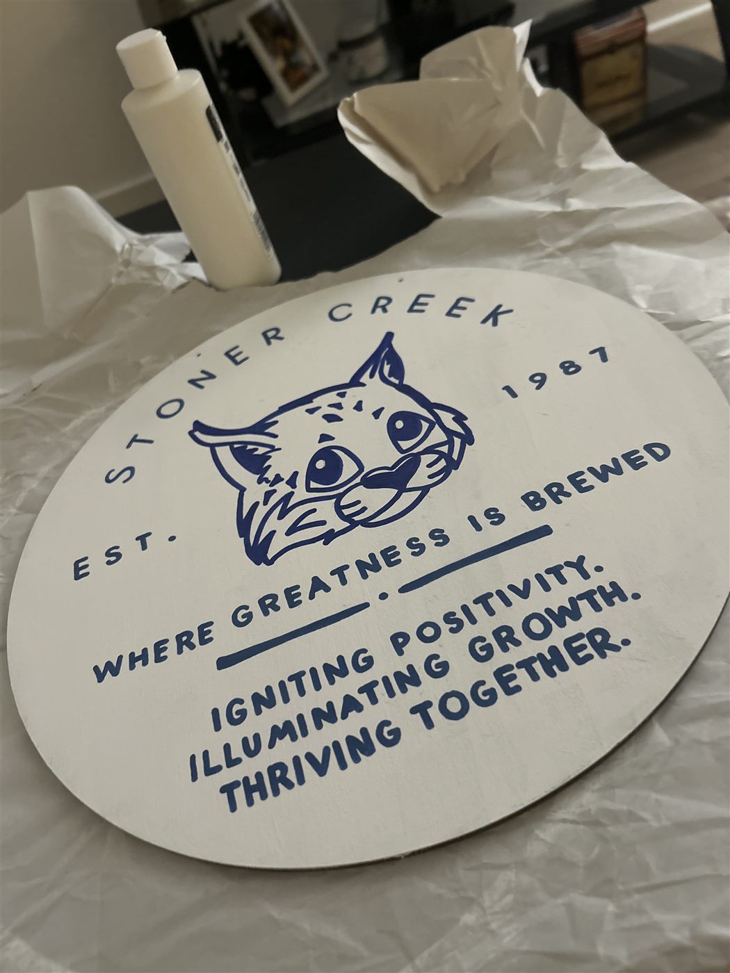 Stoner Creek hand-painted round wood sign